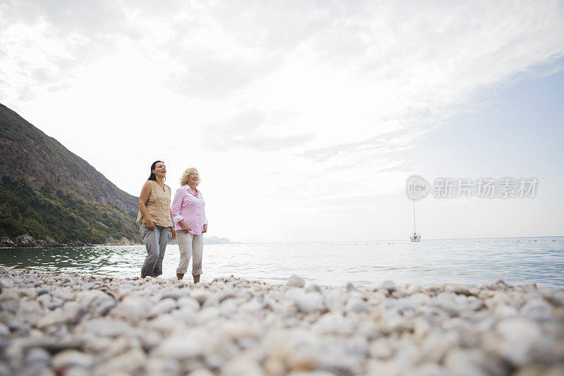 两个老年妇女在海滩上散步