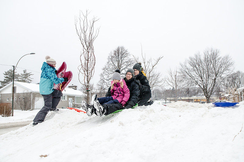 孩子和父母在雪地上滑行