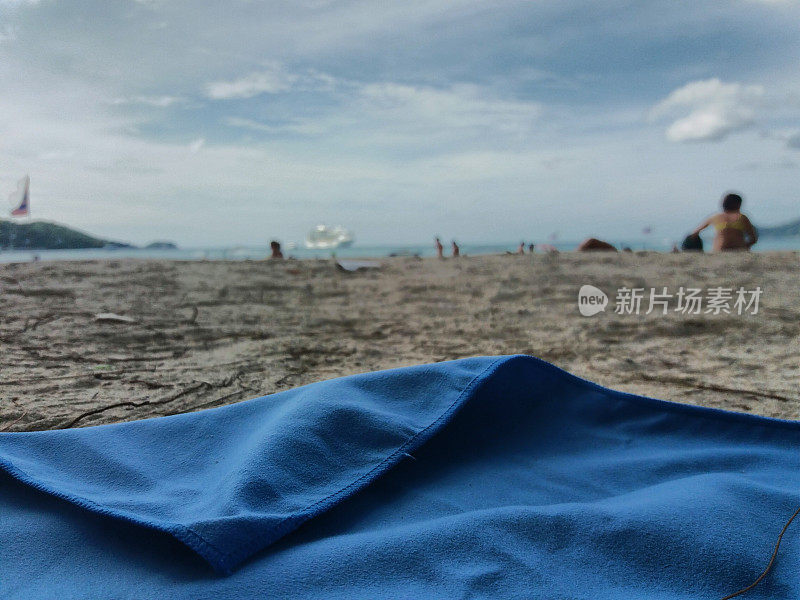 游客快速干毛巾在泰国海滩前
