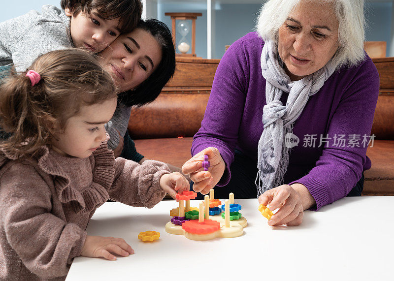 妈妈，奶奶和孙子在客厅玩玩具