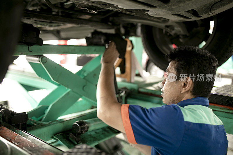 汽车技师在车库里检查汽车