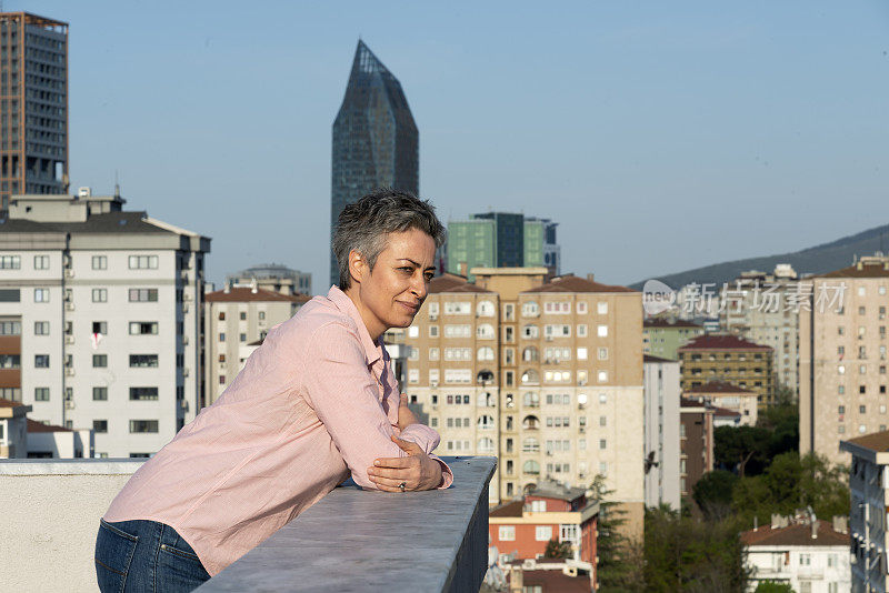 一个女人从屋顶上看城市的景色