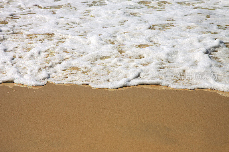 柔软的海浪在沙滩上，黄金海岸