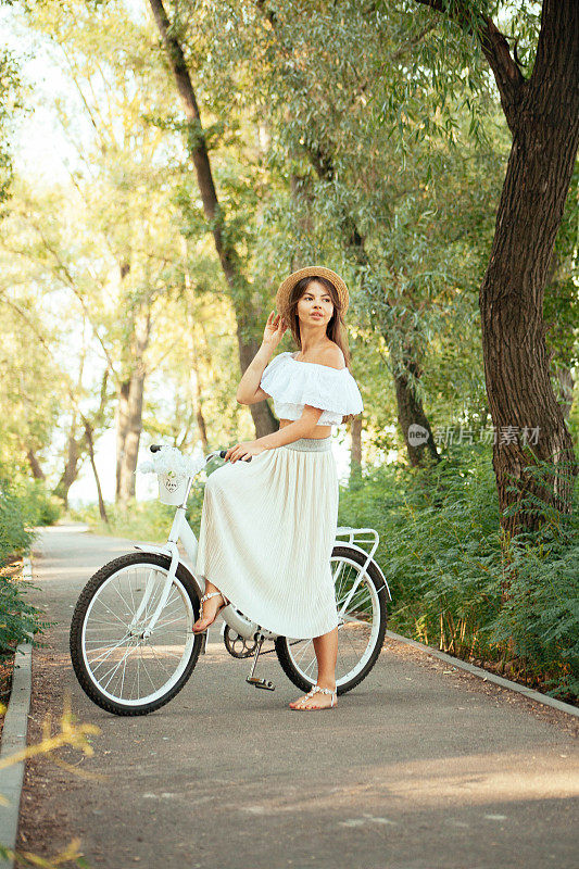 一个女孩穿着衣服坐在自行车上