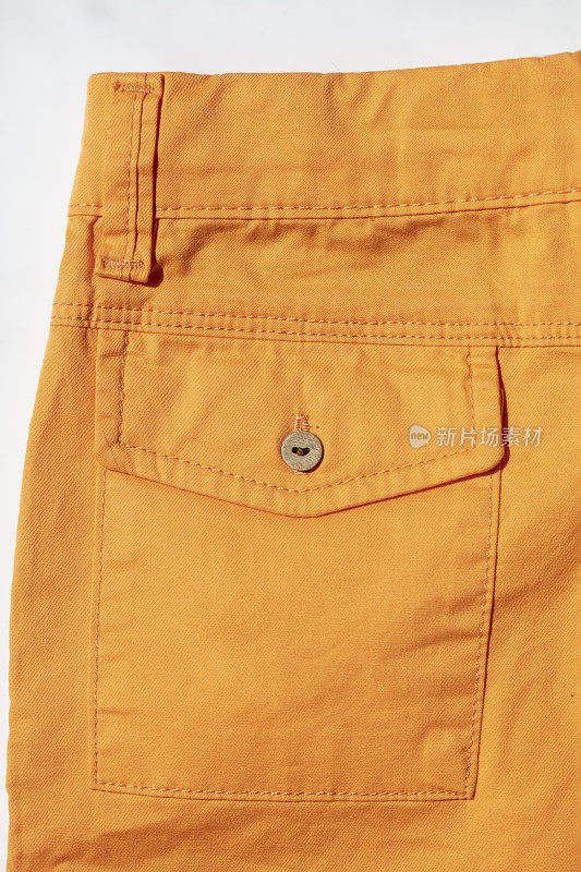 纽扣和后口袋的橙色牛仔裤裤子