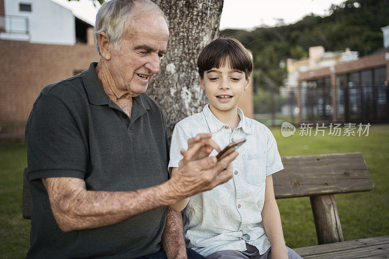 孙子教爷爷如何使用智能手机。