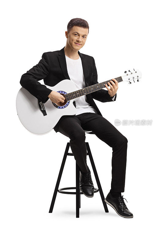 一个穿着黑色西装的优雅的年轻人坐在椅子上弹吉他