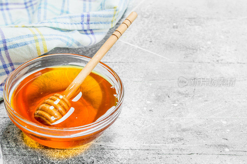 天然蜂蜜在罐子与木勺。