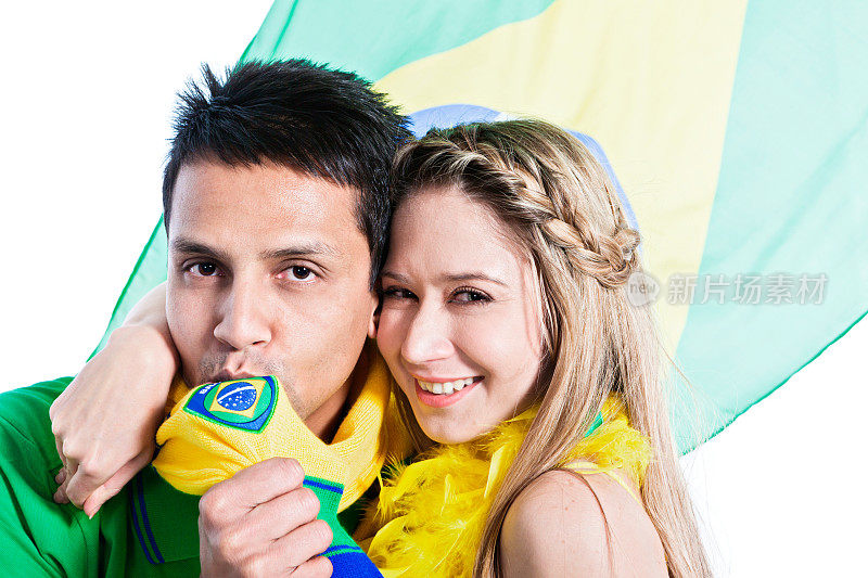 巴西体育迷亲吻国旗，女友拥抱他，微笑