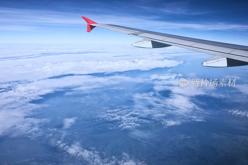 飞机飞过美丽的蓝天和白云的鸟瞰图