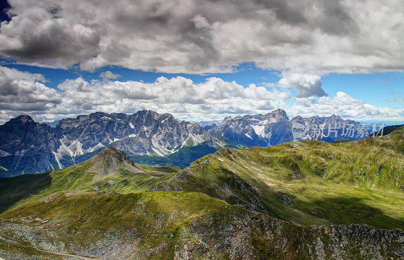 锯齿状的塞克斯顿白云石与绿色的斜坡上的卡尼阿尔卑斯山意大利