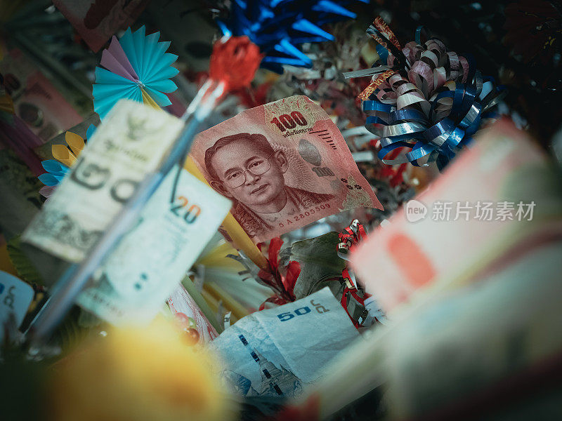 泰国纸币100泰铢放入木棒捐赠给泰国文化和节日(kathin仪式)，前景柔和
