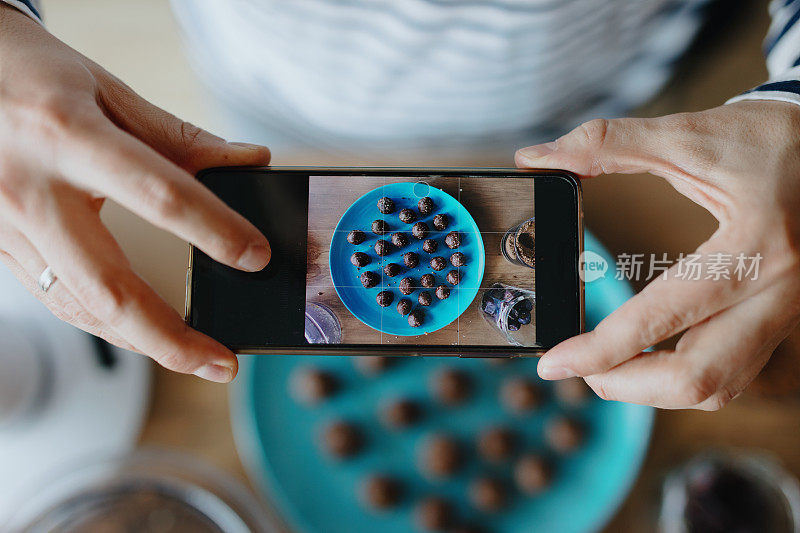 一名男子正在给自制的素食生糖果拍照