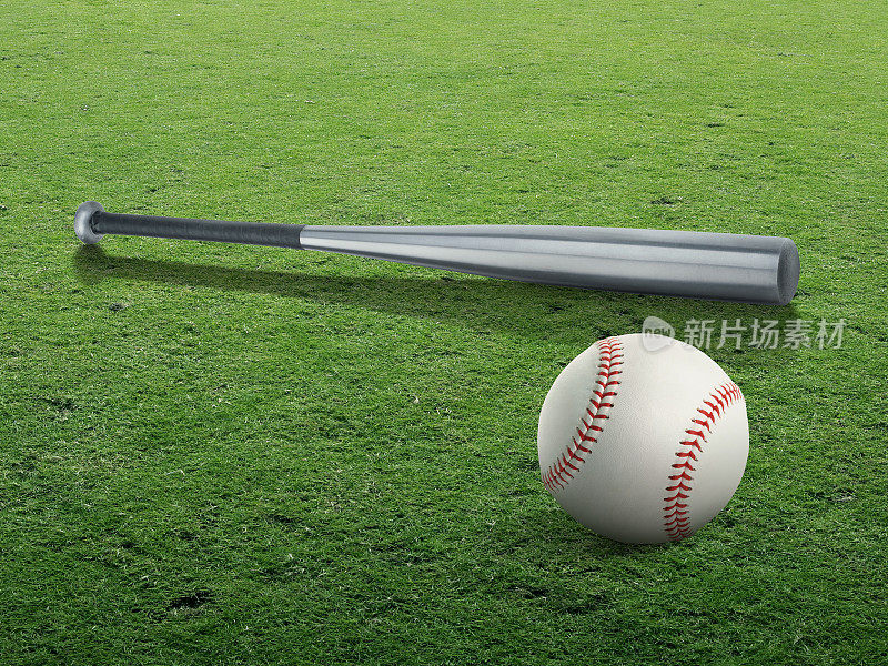 棒球棒和球孤立在清澈的绿草地上
