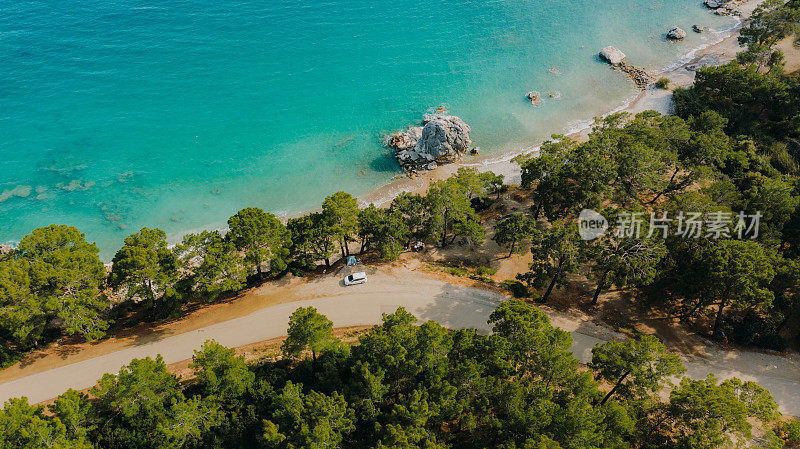 鸟瞰图，汽车和帐篷在土耳其的森林和绿松石海的风景公路