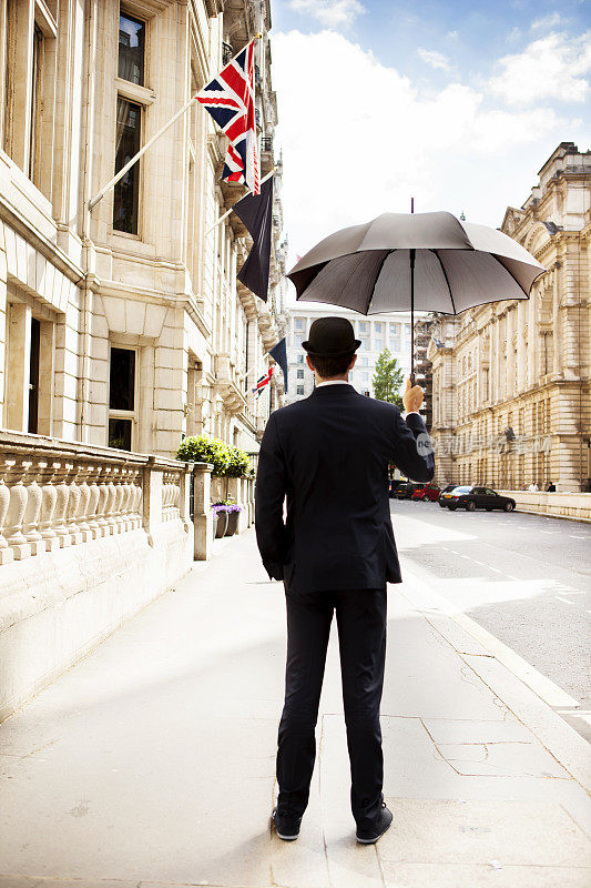 男人撑着伞看着城市