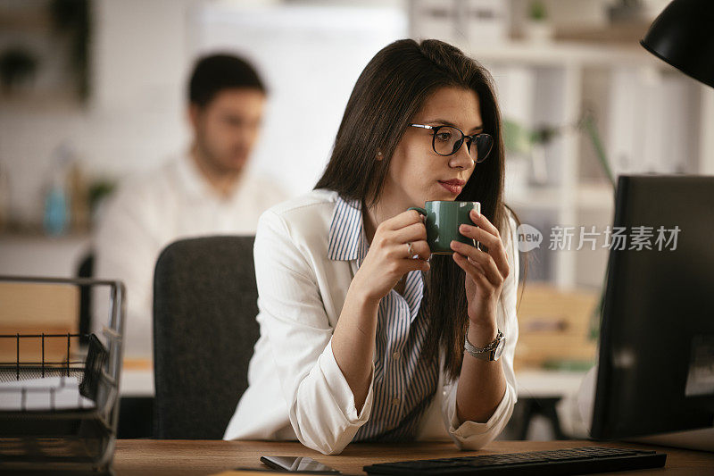 女商人在喝咖啡休息。