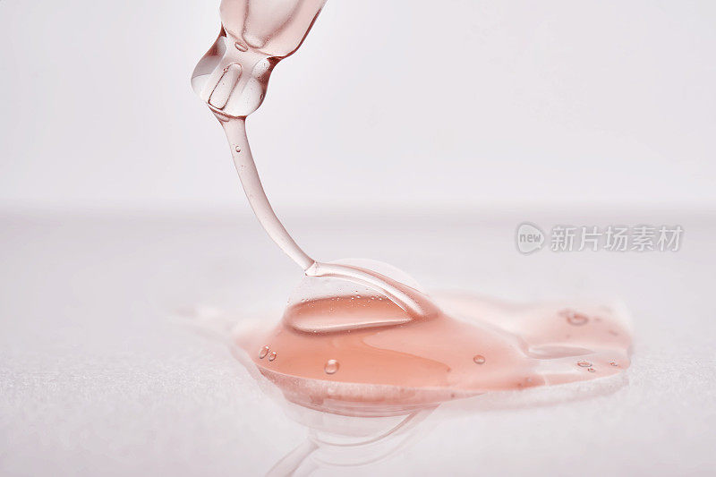 移液管有粘稠的粉红色化妆品特写。