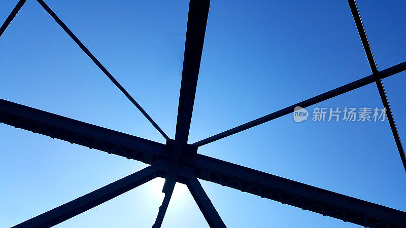 钢结构支撑上方的桥梁在蓝天背景