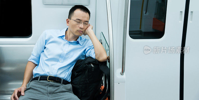 疲惫的商人睡在地铁里