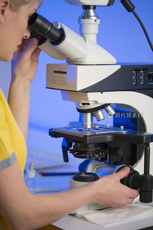 在医学实验室工作的女医生使用现代显微镜医疗设备对医学样本进行检测。实验室医疗设备用于分析的医疗设备。血液检测冠状病毒(COVID-19)、癌症、DNA定义、病毒。