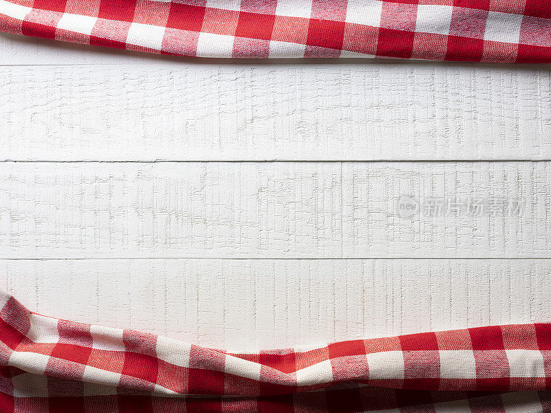白色纹理木桌与优质天然棉红色方格格子图案桌布在图像的顶部和底部。