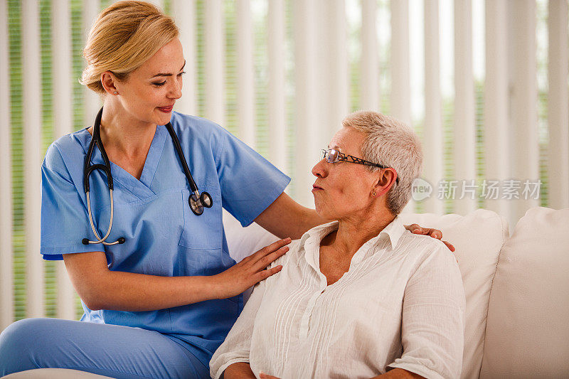 护士拥抱年长女性，同时告诉她好消息