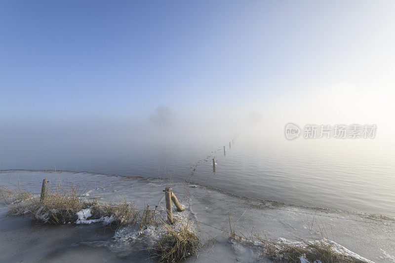 在一个寒冷的冬天的早晨，薄雾从IJssel河升起