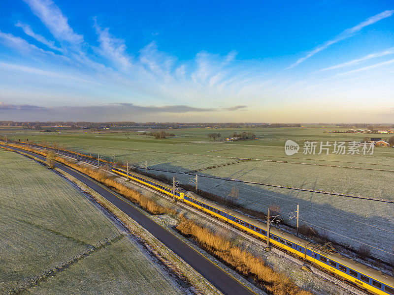 荷兰铁路公司的火车在冬天行驶在乡间