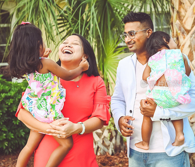 幸福的多元文化家庭，爸爸妈妈和两个女儿在欢快的肖像