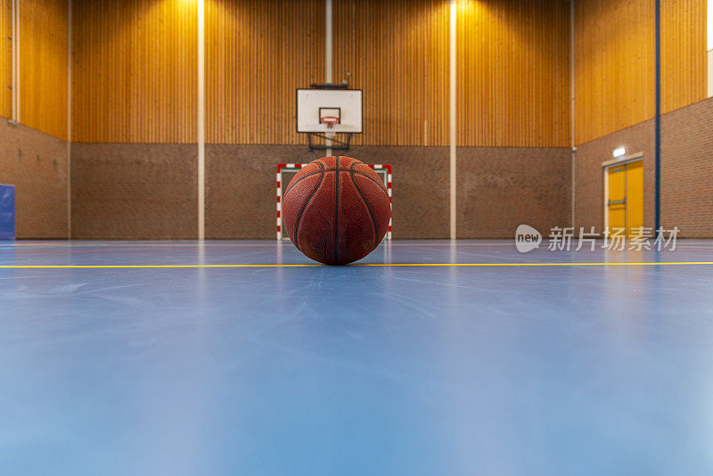 在空荡荡的体育馆打篮球。