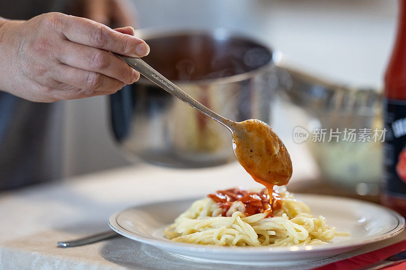 制作新鲜美味的意大利面，意大利面配上番茄酱、大蒜、罗勒和香料