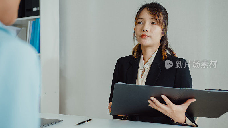 年轻的亚洲女性通过面试，坐在办公室的人力资源经理面前。人力资源，招聘机构。