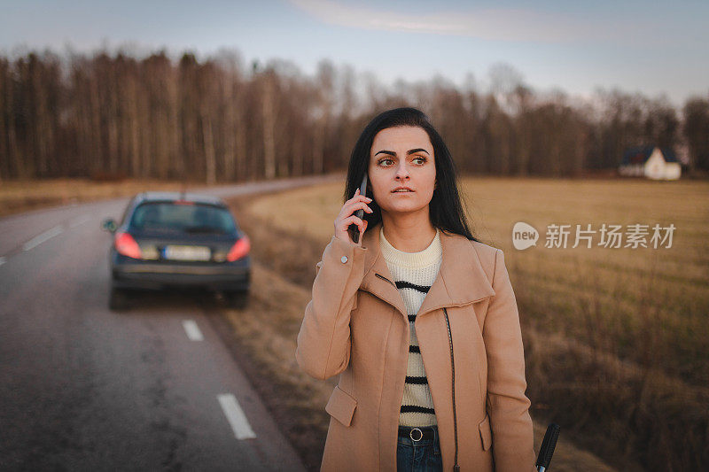 美丽的年轻女子用手机求救，因为她的车坏了