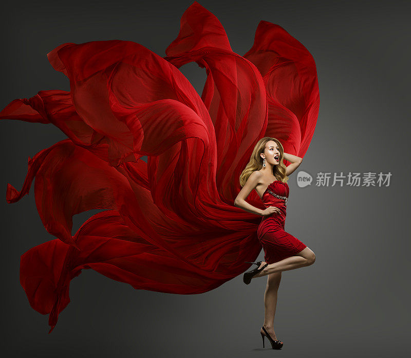 时装模特红色连衣裙，女人跳舞飞舞的织物