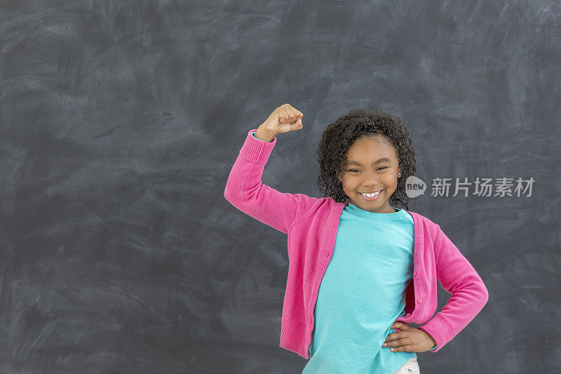 小女孩在教室里锻炼肌肉