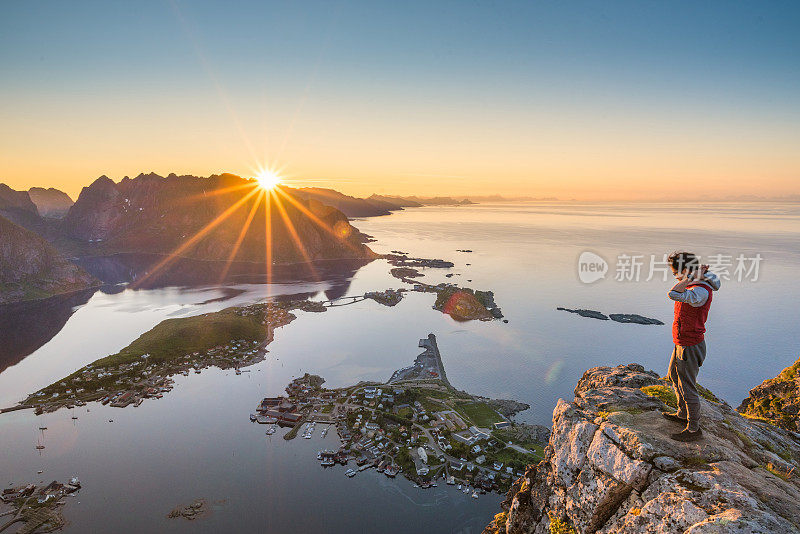 游客欣赏挪威罗浮敦群岛的夏日日落风景