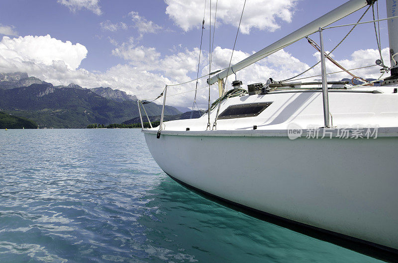 法国安纳西湖上的一艘小帆船，有蓝色的水面和复制空间