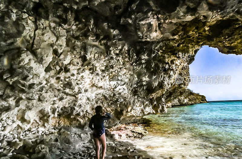 女孩探索史诗般的海洞穴在热带岛屿库拉索岛在加勒比