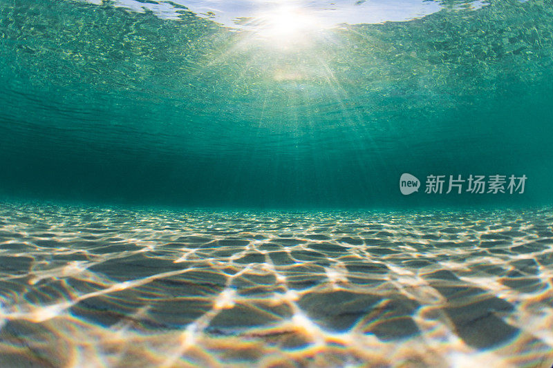 海底阳光照射在纯净的海水和沙质海底