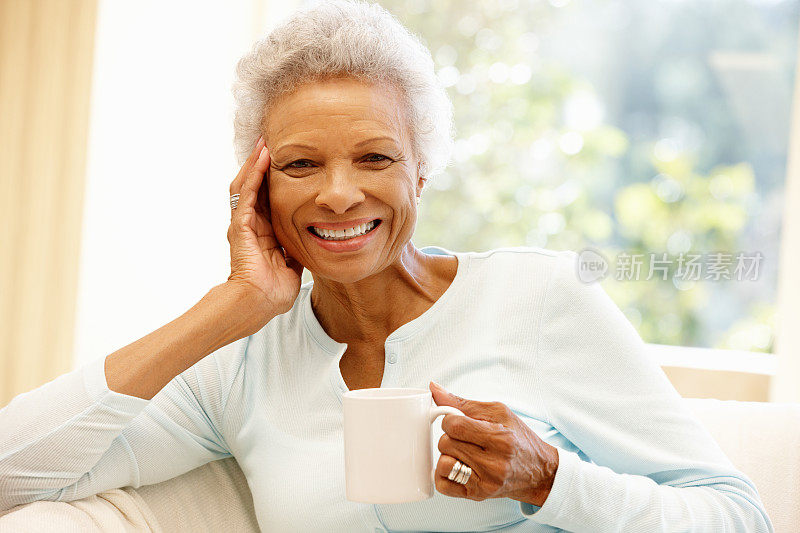 老妇人在家里喝咖啡