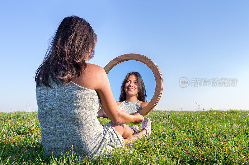 大自然中的女人看着自己的镜像