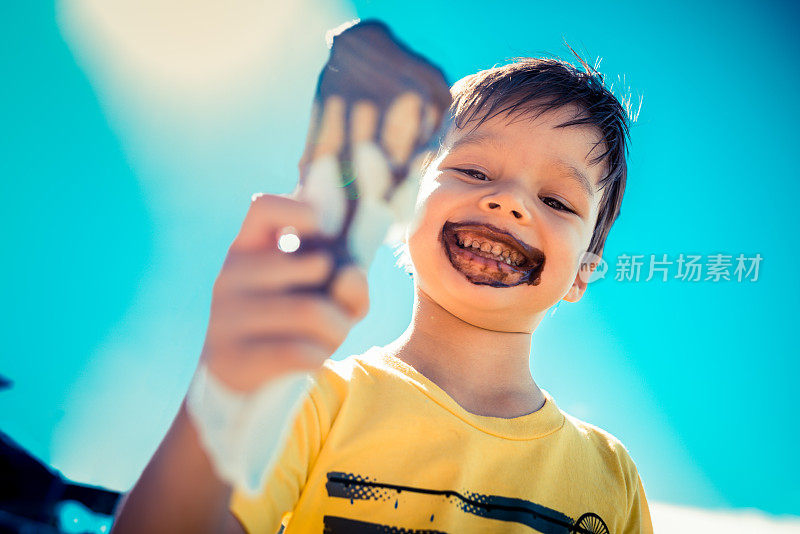 三岁的男孩吃巧克力冰淇淋