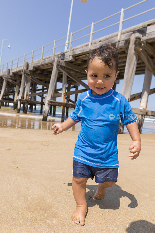 快乐的澳大利亚土著男孩在海滩上玩耍
