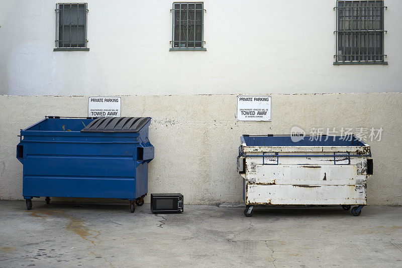 小巷里的蓝色垃圾桶和白色垃圾桶