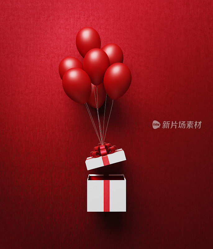 用红丝带系着的白色礼盒正在被红气球打开