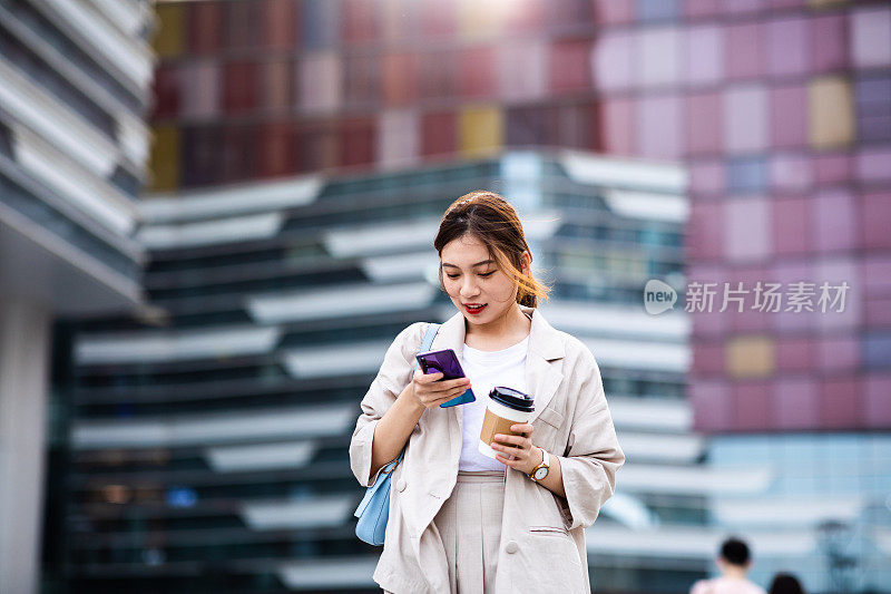 年轻女性在城市街道上使用电话