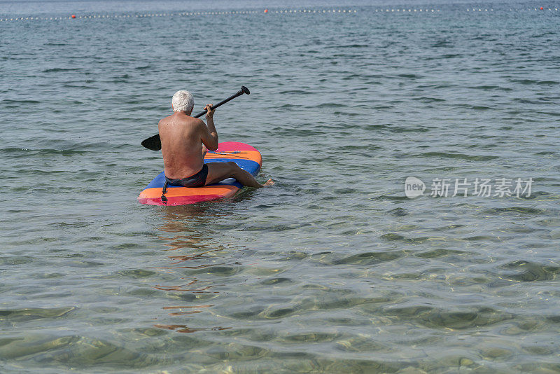 老年人坐在海浪上