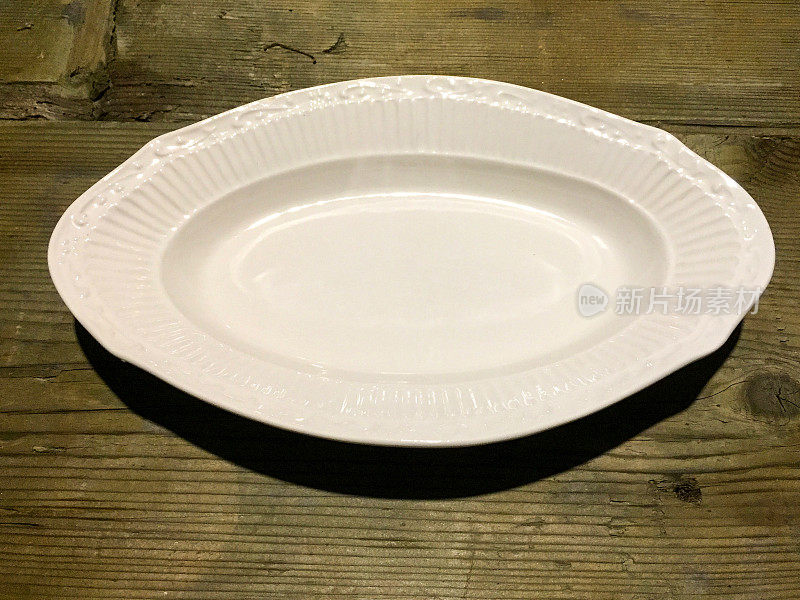 木桌上的白色空盘子