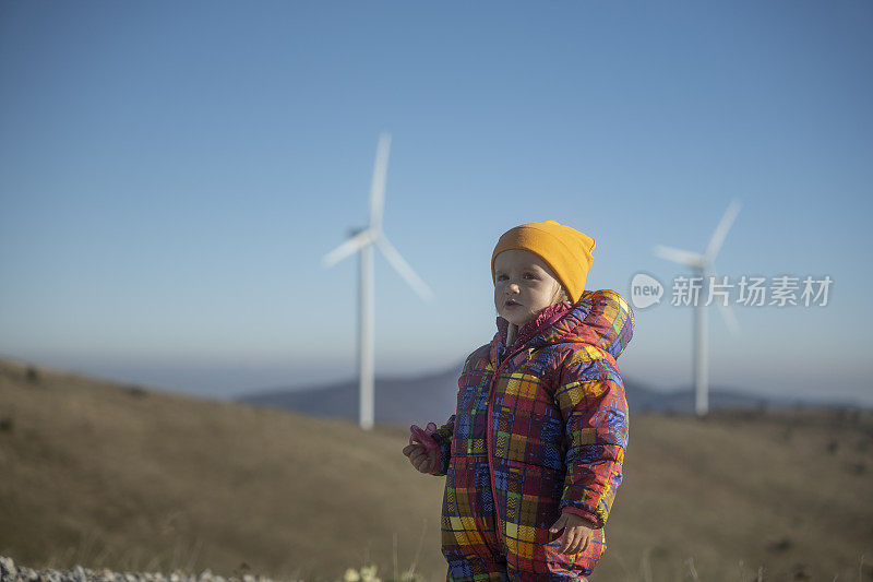 孩子在山上的风能公园，四处张望。